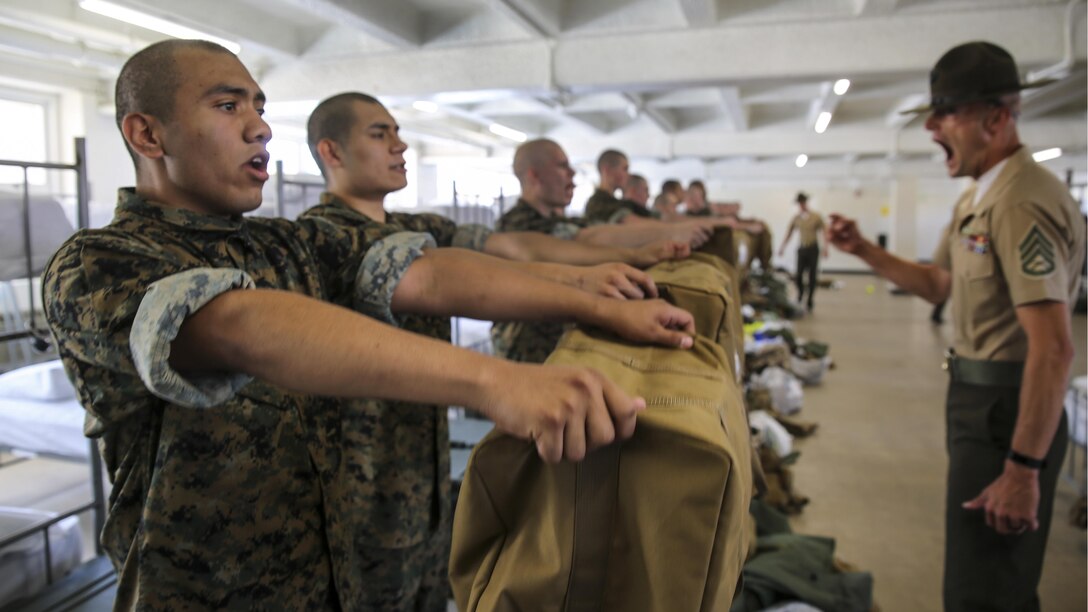 Marine Corps recruits empty their war bags during pickup at Marine Corps Recruit Depot San Diego, April 21, 2017, as a drill instructor supervises. Drill instructors ensure that the recruits fill each bag with the appropriate items and that extra gear is emptied into the recruit’s footlocker. Marine Corps photo by Cpl. Anthony Leite