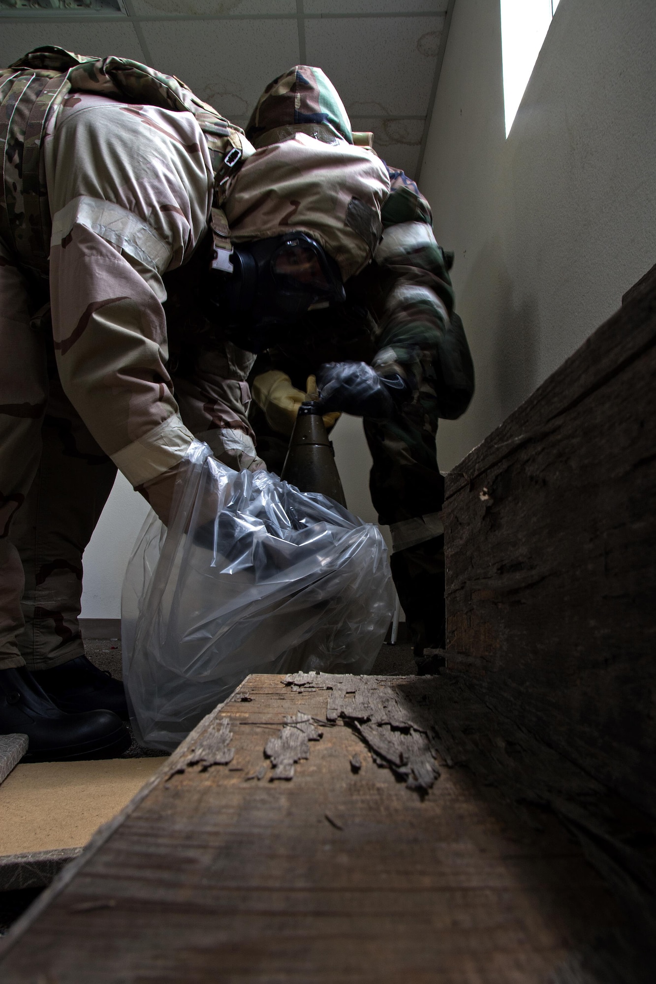 Airmen 1st Class Justin Coleman and Ryan Countryman, 60th Civil Engineer Squadron explosive ordnance technicians, gather up a dummy explosive device during a training scenario at Travis Air Force Base, Calif., on April 17, 2017. EOD techs conduct training on various threats to ensure they are prepared for deployment. (U.S.Air Force photo/Staff Sgt. Daniel Phelps)