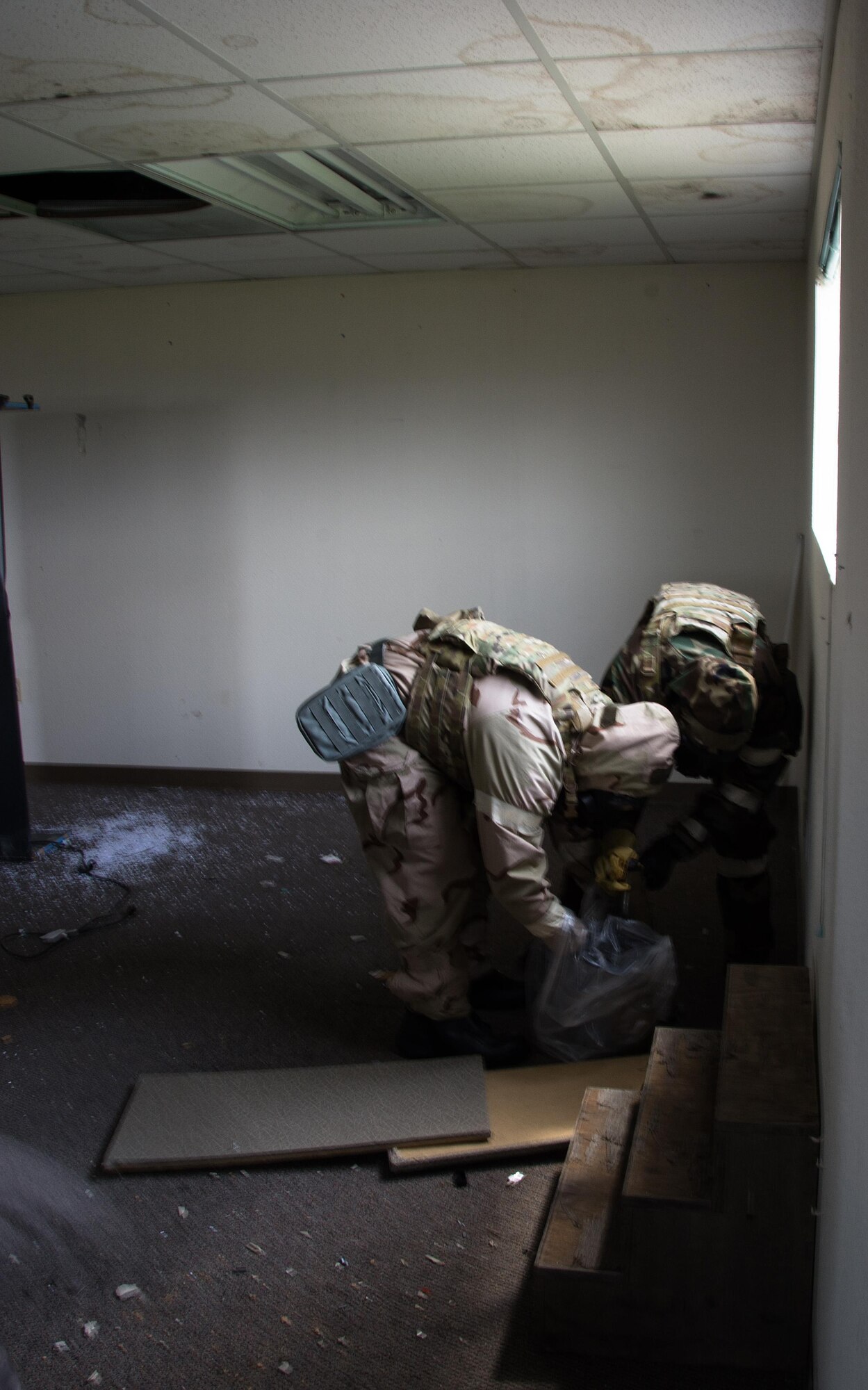 Airmen 1st Class Justin Coleman and Ryan Countryman, 60th Civil Engineer Squadron explosive ordnance technicians, gather up a dummy explosive device during a training scenario at Travis Air Force Base, Calif., on April 17, 2017. EOD techs conduct training on various threats to ensure they are prepared for deployment. (U.S.Air Force photo/Staff Sgt. Daniel Phelps)