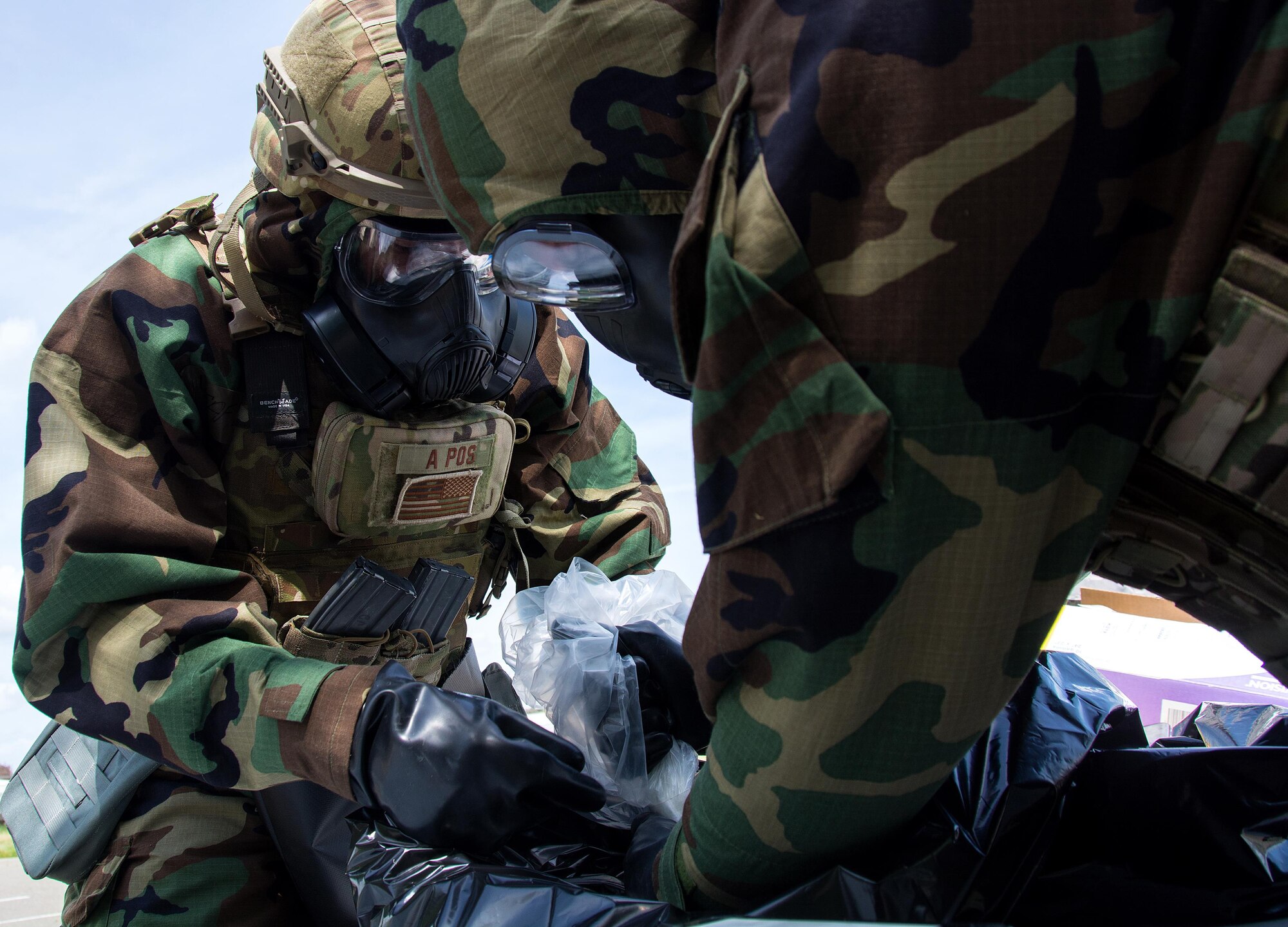 Airmen 1st Class Justin Coleman and Staff Sgt. Richard Halter, 60th Civil Engineer Squadron explosive ordnance technicians, dispose of a dummy explosive device during a training scenario at Travis Air Force Base, Calif., on April 17, 2017. EOD techs conduct training on various threats to ensure they are prepared for deployment. (U.S.Air Force photo/Staff Sgt. Daniel Phelps)
