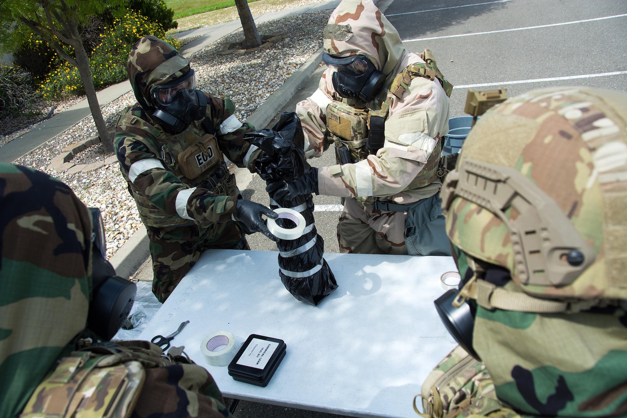Airmen 1st Class Justin Coleman, Ryan Countryman, and Bobby Potts, and Staff Sgt Richard Halter, 60th Civil Engineer Squadron explosive ordnance technicians, participate in a training scenario at Travis Air Force Base, Calif., on April 17, 2017. EOD techs conduct training on various threats to ensure they are prepared for deployment. (U.S.Air Force photo/Staff Sgt. Daniel Phelps)