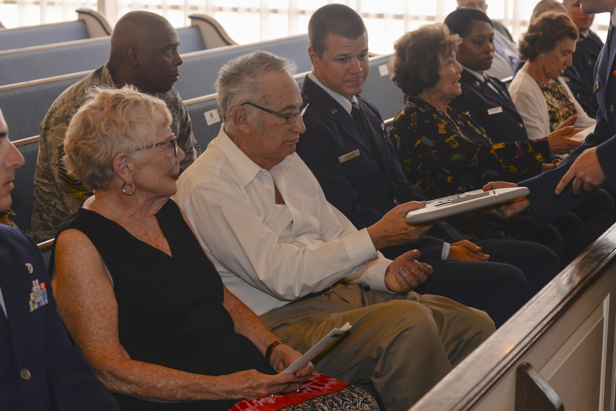 Sidney Finkel, Holocaust survivor, is presented with a memento of appreciation during a Holocaust remembrance ceremony at Davis-Monthan Air Force Base, Ariz., April 24, 2017. Airmen at D-M AFB were invited to listen to personal stories from Holocaust survivors and to participate in a candle lighting to memorialize the millions of lives lost during the genocide. (U.S. Air Force photo by Airman 1st Class Giovanni Sims)