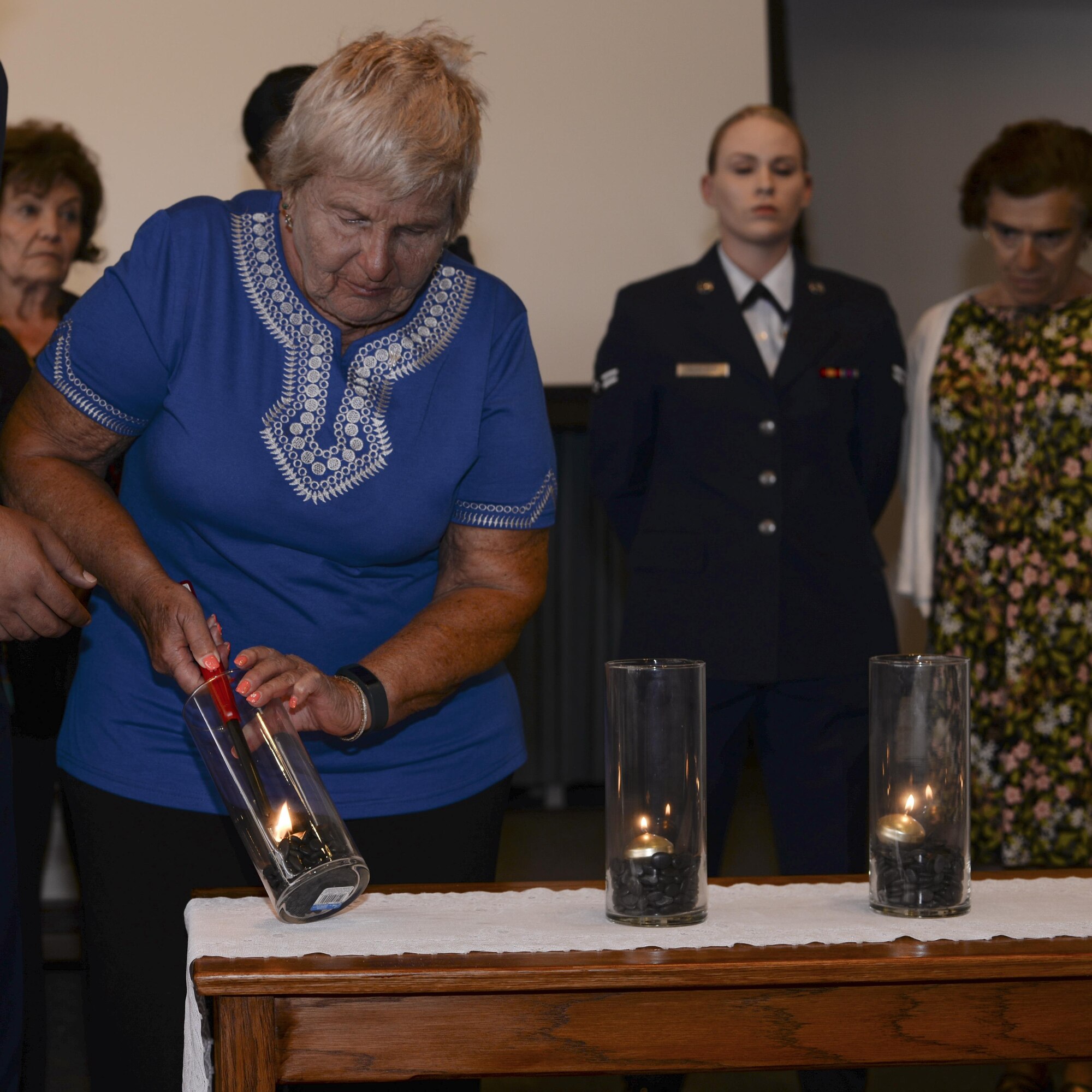 Wanda Wolosky, Holocaust survivor, lights a candle during a Holocaust remembrance ceremony at Davis-Monthan Air Force Base, Ariz., April 24, 2017. The ceremony was held to honor the 6 million Jews and millions of others that lost their lives during the Holocaust. (U.S. Air Force photo by Airman 1st Class Giovanni Sims)