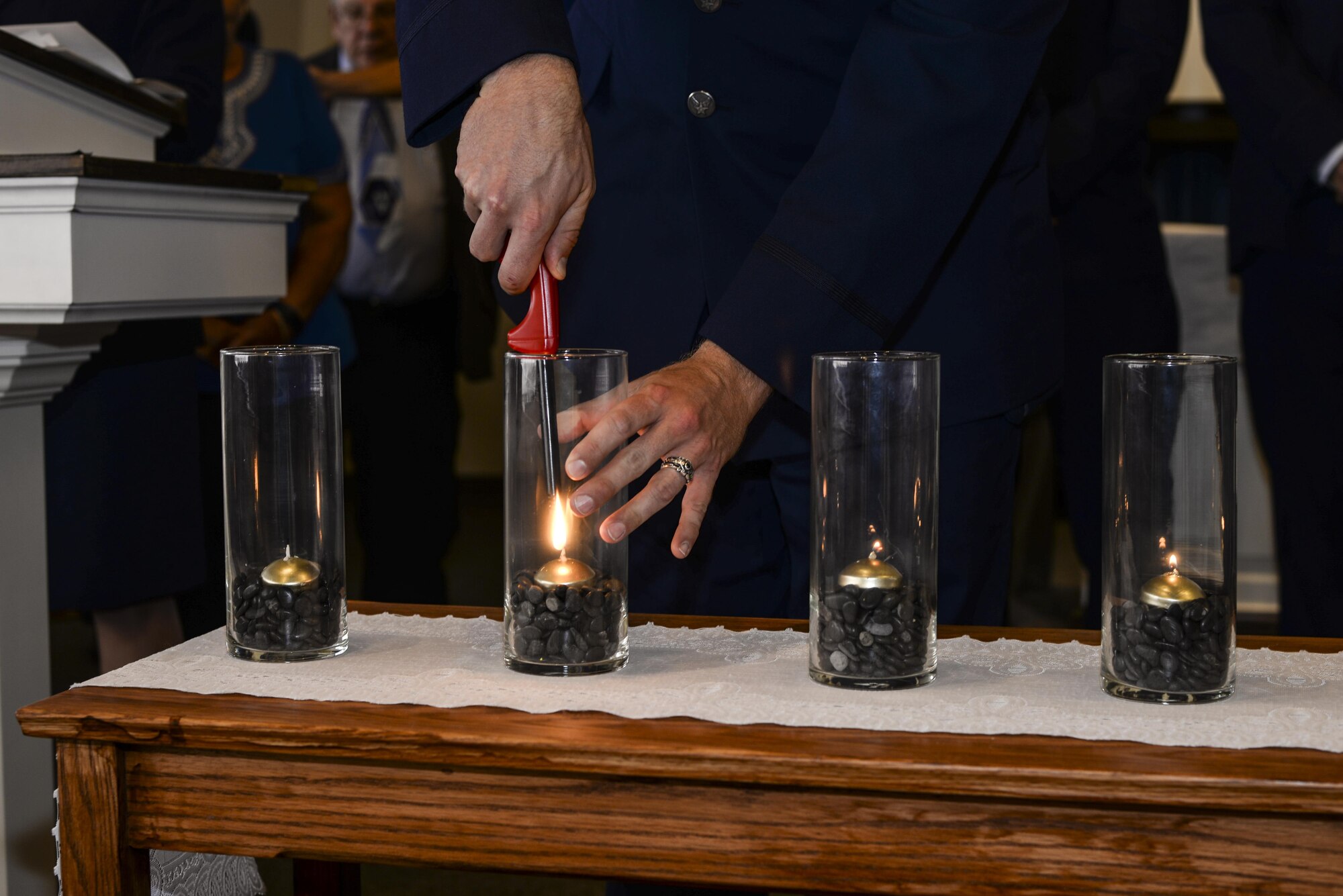U.S. Air Force Col. Scott Campbell, 355th Fighter Wing commander, lights a candle during a Holocaust remembrance ceremony at Davis-Monthan Air Force Base, Ariz., April 24, 2017. The ceremony was held to honor the 6 million Jews and millions of others that lost their lives during the Holocaust. (U.S. Air Force photo by Airman 1st Class Giovanni Sims)