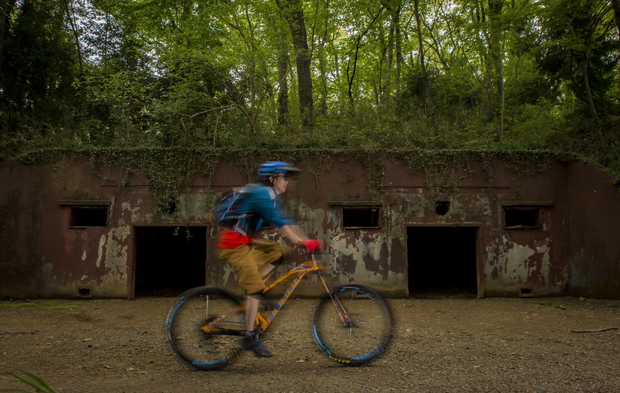 A participant in the Tour de Tama mountain bike race peddles past a WWII era bunker April 22, 2017, at Tama Hills Recreation Area, Japan. Over 85 people participated in the race with the youngest competitor being 13-years old, and the oldest was 64-years old. (U.S. Air Force photo by Airman 1st Class Donald Hudson)