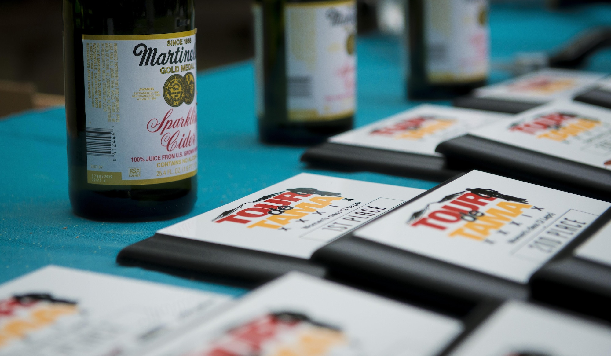 Trophies and sparkling cider rest on a table waiting to be handed out to Tour de Tama mountain bike race winners April 22, 2017, at Tama Hills Recreation Area, Japan. The race consisted of four categories: two-lap women’s and men’s heats, a three-lap open heat and four-lap expert heat; and was a mix of U.S. military members, dependents and Japanese civilians. (U.S. Air Force photo by Airman 1st Class Donald Hudson)