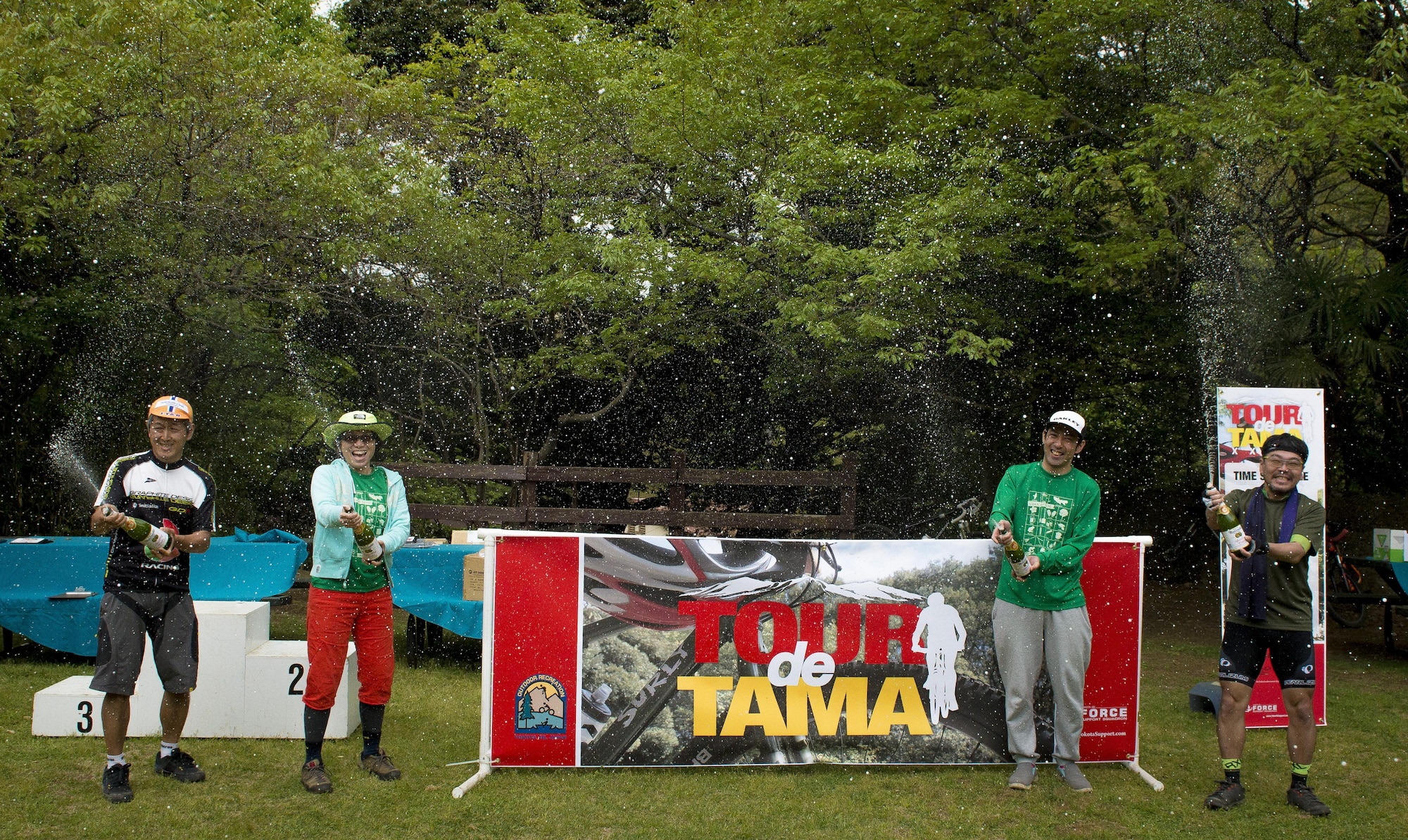 The winners of the Tour de Tama mountain bike race spray sparkling cider after the race April 22, 2017, at Tama Hills Recreation Area, Japan. The race consisted of four categories: two-lap women’s and men’s heats, a three-lap open heat and four-lap expert heat; and was a mix of U.S. military members, dependents and Japanese civilians. (U.S. Air Force photo by Airman 1st Class Donald Hudson)
