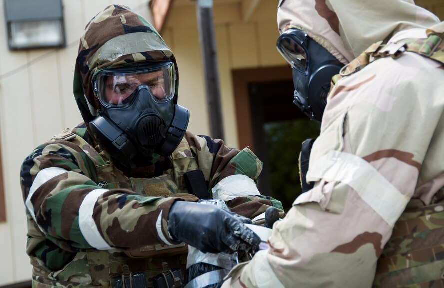 Airmen 1st Class Justin Coleman and Ryan Countryman, 60th Civil Engineer Squadron explosive ordnance technicians, dispose of a dummy explosive device during a training scenario at Travis Air Force Base, Calif., on April 17, 2017. EOD techs conduct training on various threats to ensure they are prepared for deployment. (U.S.Air Force photo/Staff Sgt. Daniel Phelps)
