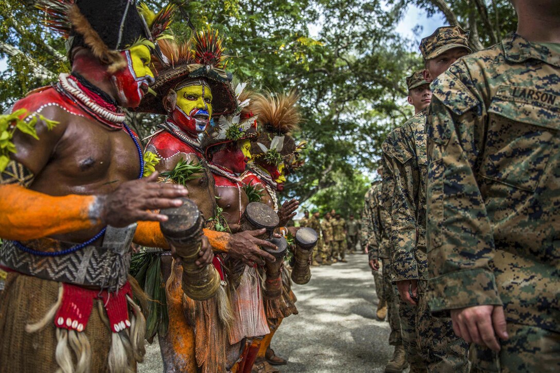Papua New Guinean folk dancers line up with U.S. Marines and sailors during a banquet as part of a closing ceremony for a military tactics training exchange at Taurama Barracks, Papua New Guinea, April 18, 2017. Marines and sailors assigned to the 11th Marine Expeditionary Unit conducted the training with Papua New Guinea Defense Force service members. Marine Corps photo by Cpl. Devan K. Gowans