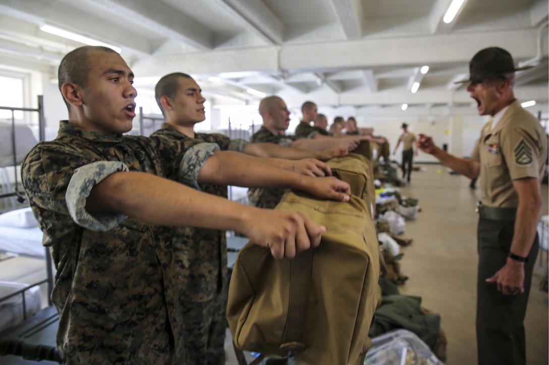 Marine Corps recruits empty their war bags during pickup at Marine Corps Recruit Depot San Diego, April 21, 2017, as a drill instructor supervises. Drill instructors ensure that the recruits fill each bag with the appropriate items and that extra gear is emptied into the recruit’s footlocker. Marine Corps photo by Cpl. Anthony Leite