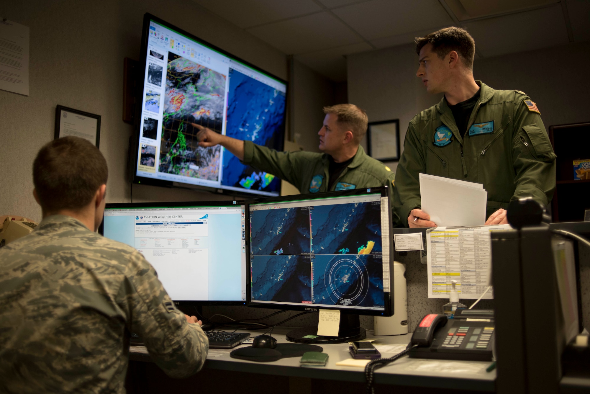 U.S. Navy Lt. Cmdr. Daniel Bradley, Fleet Logistics Support Squadron 51 C-20G Gulfstream pilot, stops by the 18th Operations Support Squadron weather flight for a weather update April 21, 2017, at Kadena Air Base, Japan. The weather flight is responsible for keeping the base and flyers updated on current weather conditions as well as relaying information to aircraft in the sky regarding any changes that might affect their flight. (U.S. Air Force photo by Senior Airman John Linzmeier)