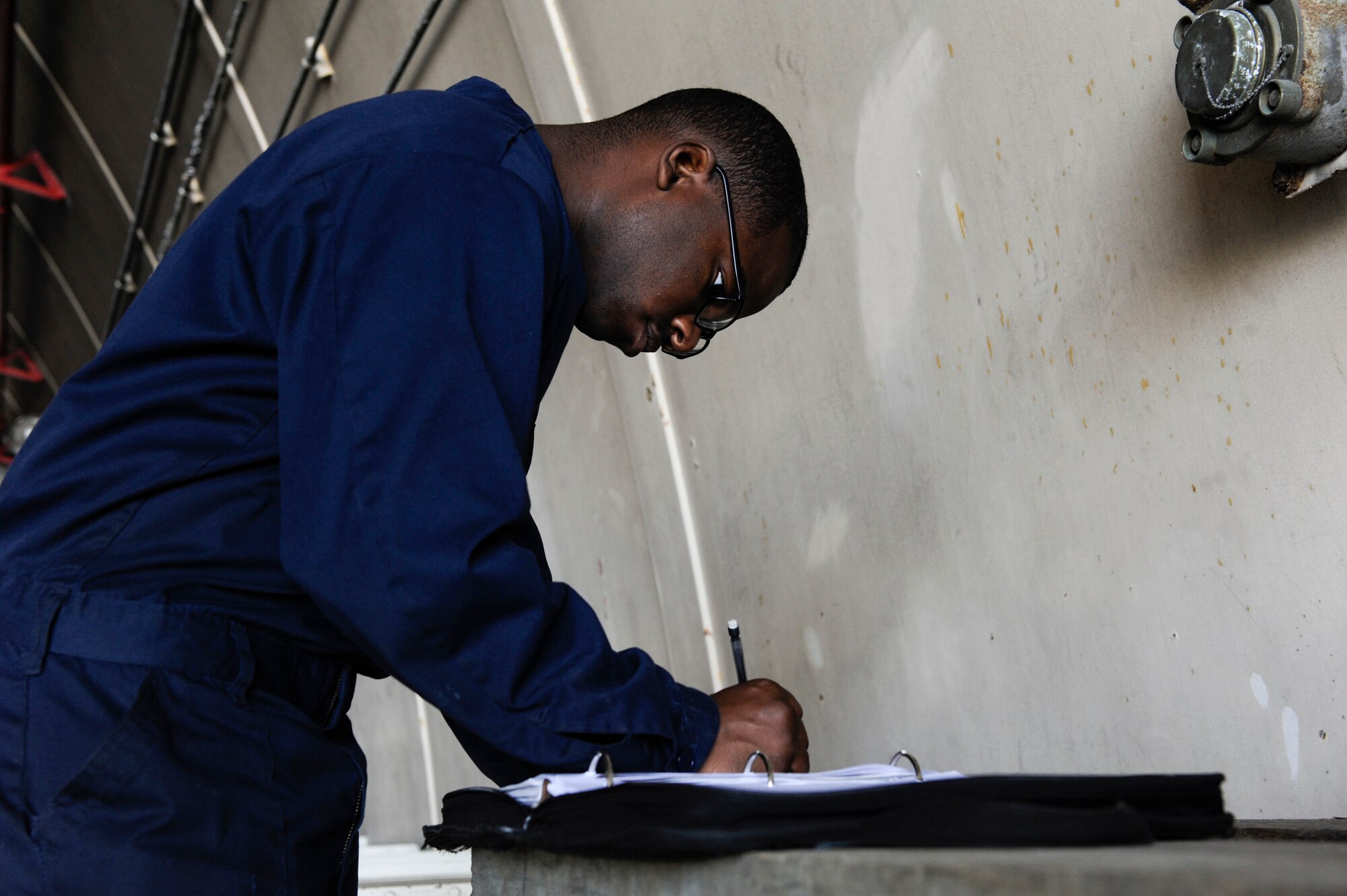 U.S. Air Force Airman 1st Class Tychaun Kingston, 44th Aircraft Maintenance Unit crew chief, reviews a training checklist April 24, 2017, at Kadena Air Base, Japan. Training checklists contain details as to what tasks need to be accomplished for a specific training session. (U.S. Air Force photo by Senior Airman Lynette M. Rolen)