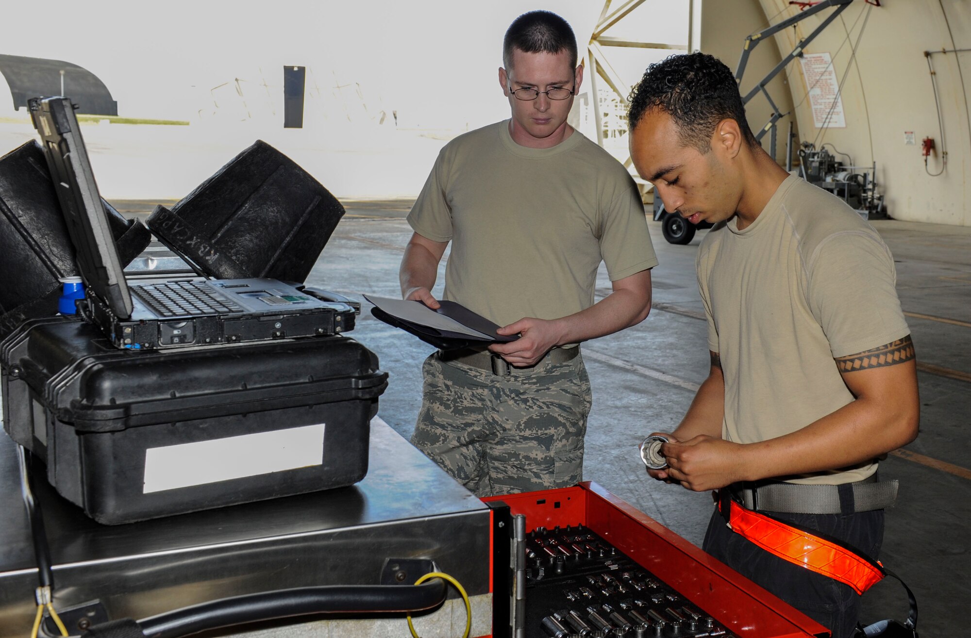 U.S. Air Force Tech. Sgt. Timothy Peppler, 372nd Training Squadron, Detachment 15, F-15 Eagle aircraft maintenance instructor, observes Senior Airman Devon Moore, 67th Aircraft Maintenance Unit crew chief, as he selects tools for maintenance training April 24, 2017, at Kadena Air Base, Japan. During maintenance training, crew chiefs review what tools are needed for specific tasks. (U.S. Air Force photo by Senior Airman Lynette M. Rolen)
