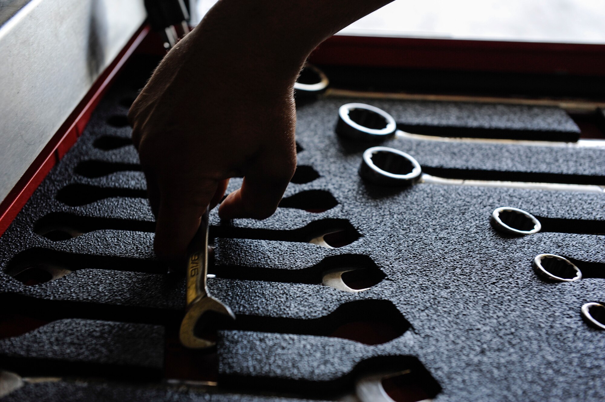 U.S. Air Force Senior Airman Devon Moore, 67th Aircraft Maintenance Unit crew chief, selects a tool for maintenance training April 24, 2017, at Kadena Air Base, Japan. Frequent training ensures crew chiefs maintain job proficiency. (U.S. Air Force photo by Senior Airman Lynette M. Rolen)
