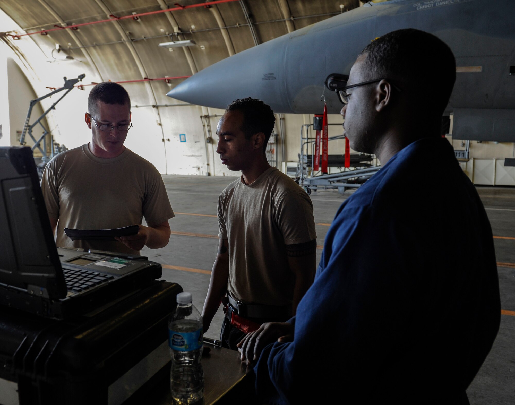 U.S. Air Force Tech. Sgt. Timothy Peppler, 372nd Training Squadron, Detachment 15, F-15 Eagle aircraft maintenance instructor, Senior Airman Devon Moore, 67th Aircraft Maintenance Unit crew chief, and Airman 1st Class Tychaun Kingston, 44th AMU crew chief, review training content April 24, 2017, at Kadena Air Base, Japan. The 372nd TRS, Det. 15, provides necessary upgrade training classes for Airmen stationed on Kadena. (U.S. Air Force photo by Senior Airman Lynette M. Rolen)