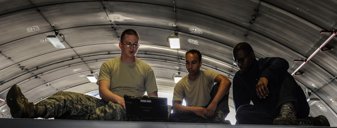 U.S. Air Force Tech. Sgt. Timothy Peppler, 372nd Training Squadron, Detachment 15, F-15 Eagle aircraft maintenance instructor, Senior Airman Devon Moore, 67th Aircraft Maintenance Unit crew chief, and Airman 1st Class Tychaun Kingston, 44th AMU crew chief, review a technical order April 24, 2017, at Kadena Air Base, Japan. The verbiage of the technical order dictates how work needs to be performed on a certain part of the aircraft. (U.S. Air Force photo by Senior Airman Lynette M. Rolen)