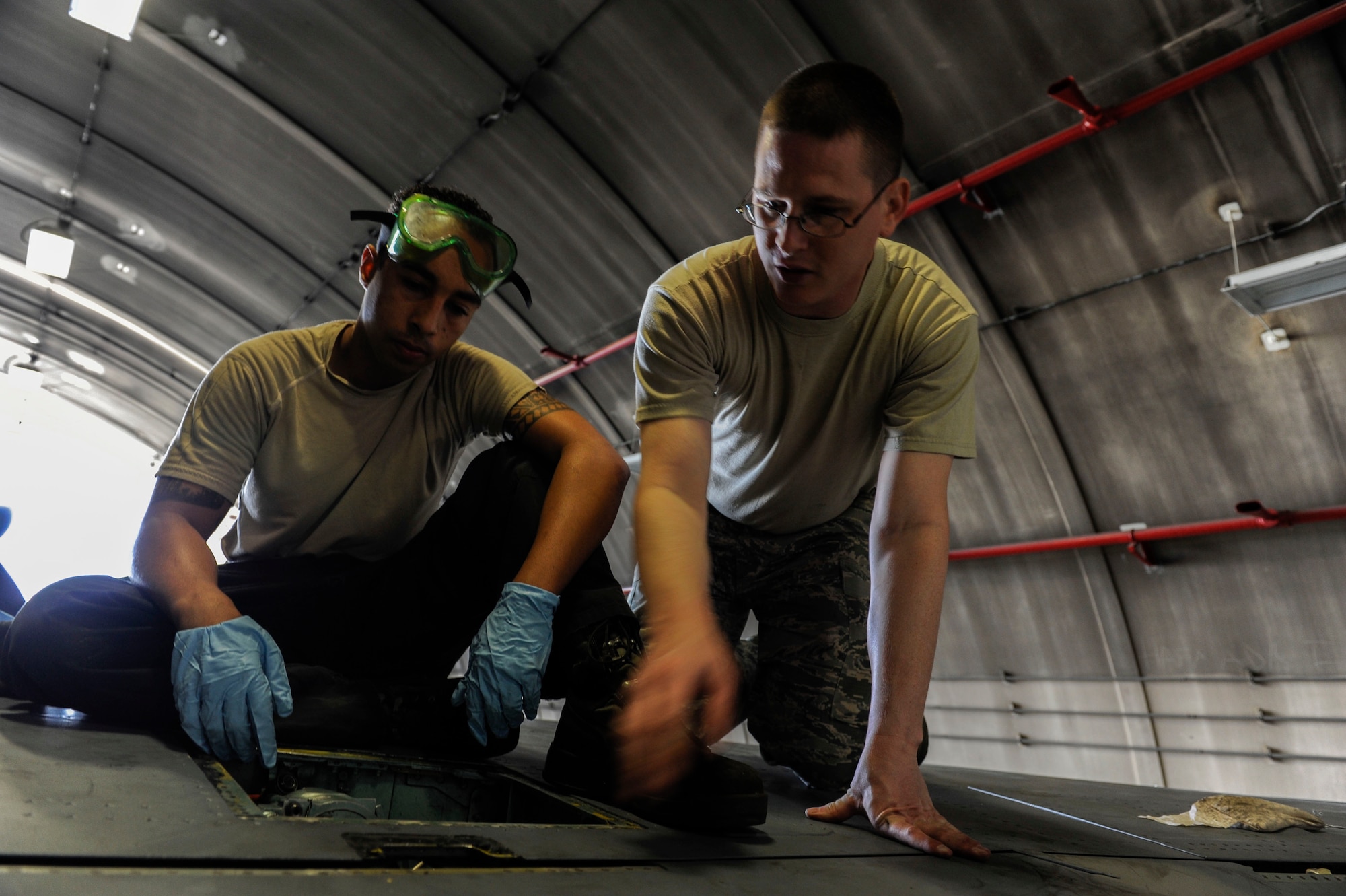 U.S. Air Force Senior Airman Devon Moore, 67th Aircraft Maintenance Unit crew chief and Tech. Sgt. Timothy Peppler, 372nd Training Squadron, Detachment 15, F-15 Eagle aircraft maintenance instructor perform maintenance on a flap actuator on an F-15 April 24, 2017, at Kadena Air Base, Japan. The flap actuator assists with maneuverability of the aircraft. (U.S. Air Force photo by Senior Airman Lynette M. Rolen)