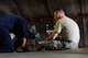 U.S. Air Force Airman 1st Class Tychaun Kingston, 44th Aircraft Maintenance Unit crew chief, unscrews a panel on an F-15 Eagle as Tech. Sgt. Timothy Peppler, 372nd Training Squadron, Detachment 15, F-15 aircraft maintenance instructor, supervises April 24, 2017, at Kadena Air Base, Japan. Aircraft maintenance instructors assigned to the 372nd TRS, Det. 15, assist with providing over 2,000 hours of instruction to Airmen. (U.S. Air Force photo by Senior Airman Lynette M. Rolen)