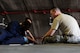 U.S. Air Force Airman 1st Class Tychaun Kingston, 44th Aircraft Maintenance Unit crew chief, performs maintenance on an aileron switching valve as Tech. Sgt. Timothy Peeler, 372nd Training Squadron, Detachment 15, F-15 Eagle aircraft maintenance instructor, observes April 24, 2017, at Kadena Air Base, Japan. The aileron switching valve is one of the hydraulic systems on the F-15 Eagle. (U.S. Air Force photo by Senior Airman Lynette M. Rolen)