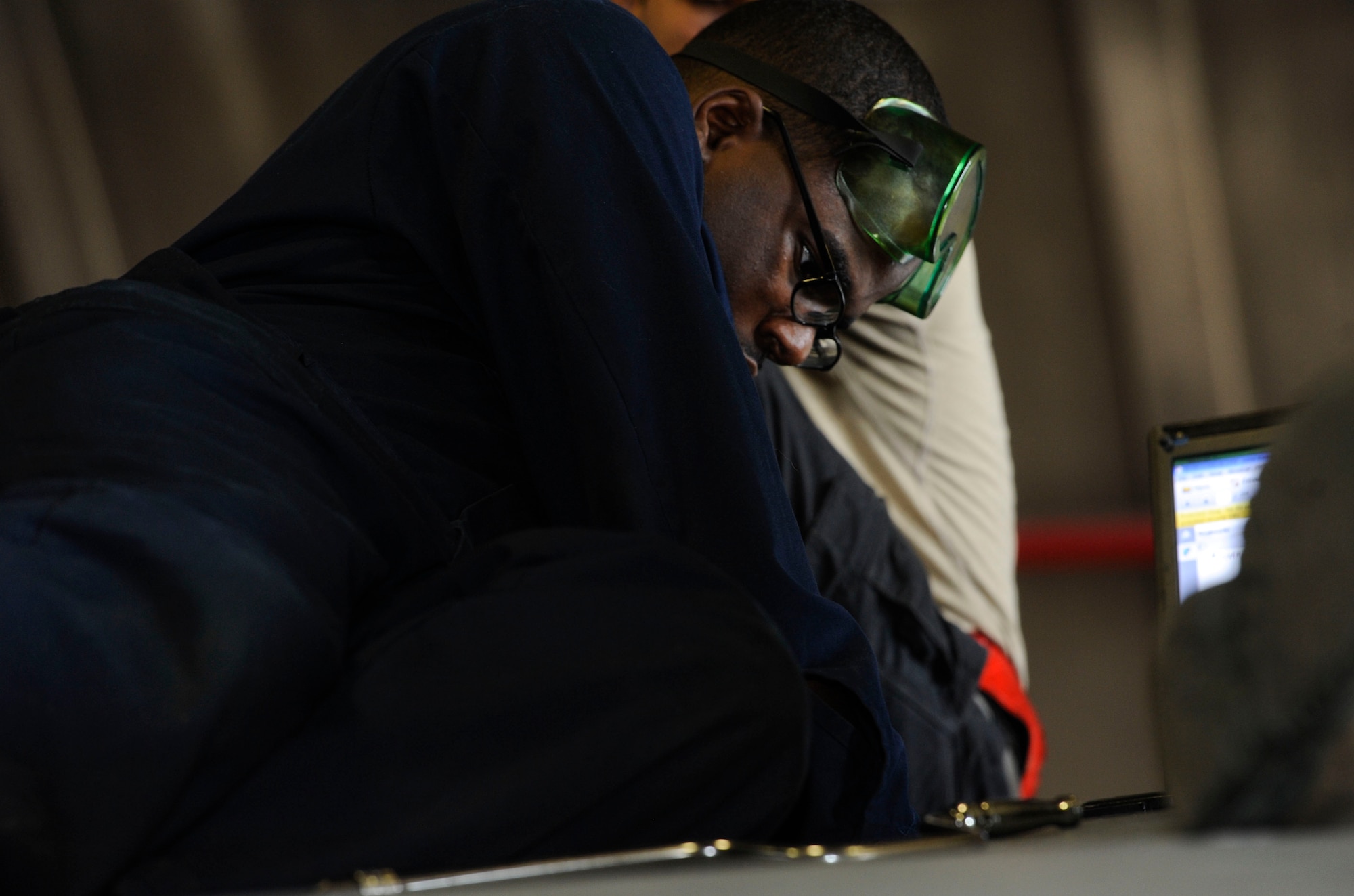 U.S. Air Force Airman 1st Class Tychaun Kingston, 44th Aircraft Maintenance Unit crew chief, performs maintenance on an aileron switching valve April 24, 2017, at Kadena Air Base, Japan. The aileron switching valve directs hydraulic fluid to the ailerons, providing pressure to the rudders. (U.S. Air Force photo by Senior Airman Lynette M. Rolen)
