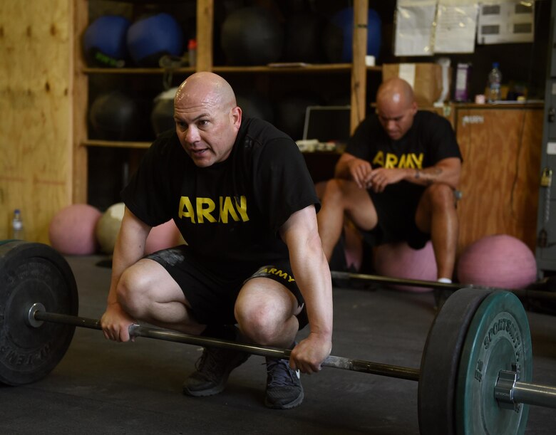 U.S. Army Master Sgt. Fernando Gonzalez, U.S. Forces Afghanistan, takes a breather before conducting an exercise during a fitness competition April 22, 2017, at Bagram Airfield, Afghanistan. The competition brought together service members to promote fitness and boost camaraderie. (U.S. Air Force photo by Staff Sgt. Benjamin Gonsier)