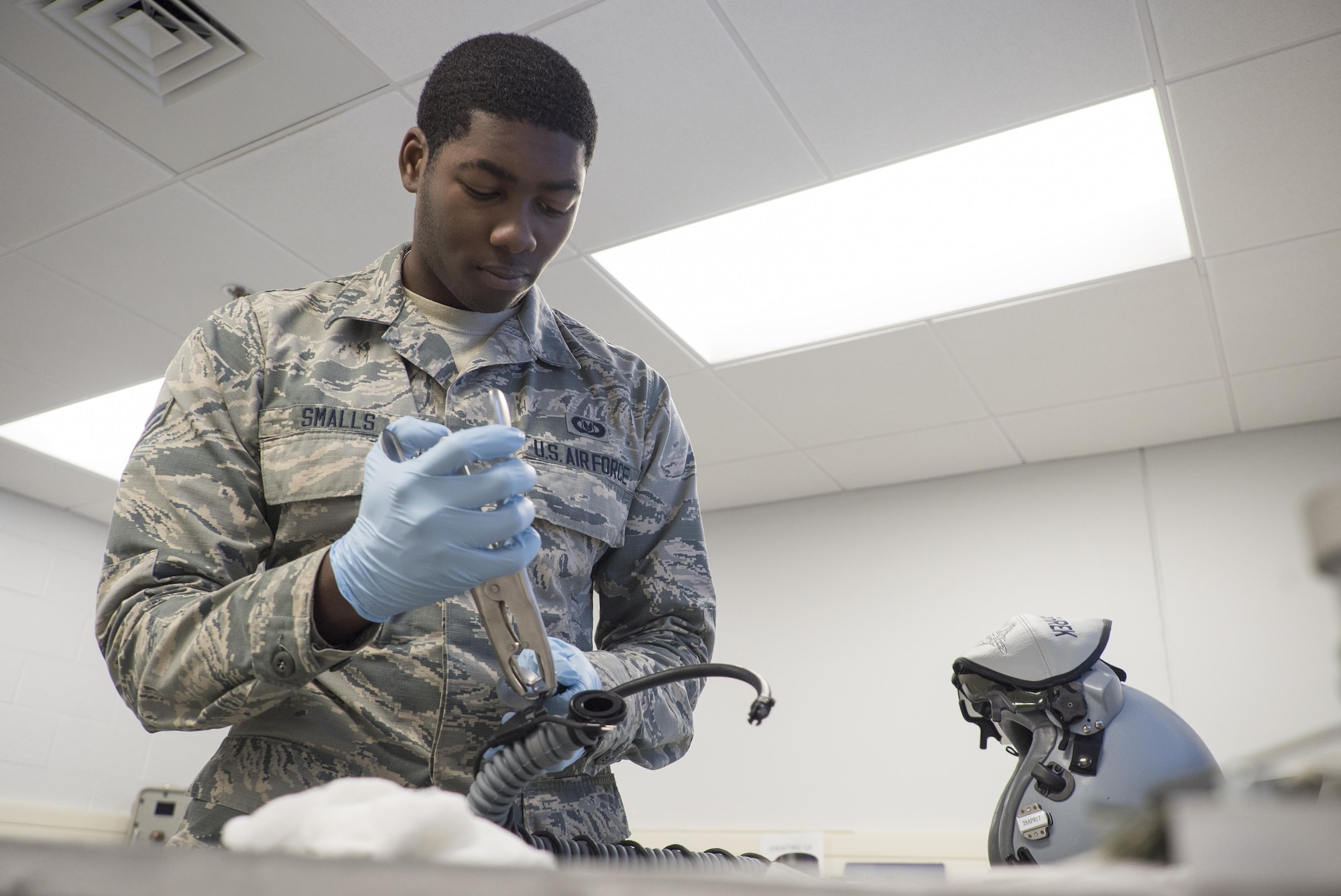 Airman 1st Class Khalil Smalls, 339th Flight Test Squadron aircrew flight equipment helper, reassembles components of an MBU-20/P oxygen mask April 26, 2017, at Robins Air Force Base, Georgia. The mask provides pressure breathing for aircrew and reduces the probability of G-induced loss of consciousness. (U.S. Air Force photo by Jamal D. Sutter)