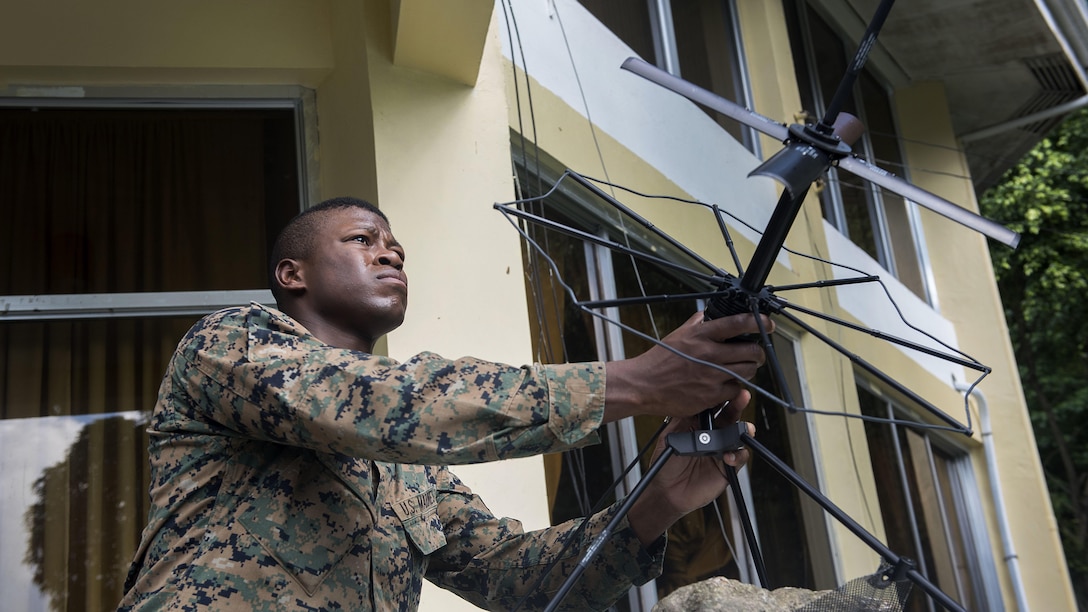 U.S. Marine Staff Sgt. Alexander Davis adjusts a satellite communication antenna during Balikatan 2017 at Camp Lapulapu, Cebu, April 25, 2017. Balikatan is an annual U.S.-Philippine military bilateral exercise focused on a variety of missions, including humanitarian assistance and disaster relief, and counterterrorism. (U.S. Air Force photo by Senior Airman Corey Pettis)