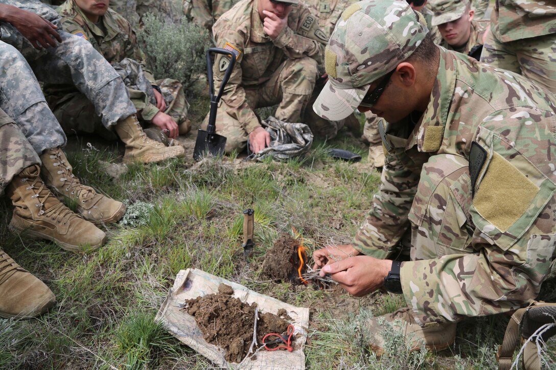Air Force Tech. Sgt. Isaac Houston keeps an evasion fire burning during training at Yakima Training Center, Yakima, Wash., April 25, 2017. Soldiers focused on the five basic needs for desert conditions. Army photo by Sgt. Kalie Jones