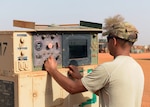 Staff Sgt. Eric Erquiza, 768th Expeditionary Air Base Squadron NCO in charge of Power Production, checks the settings on a generator at Nigerien Air Base 101, Niger, April 1, 2017. Periodic maintenance on the generators helps to cut down on wear and tear, and keeps them operating efficiently. (U.S. Air Force photo by Senior Airman Jimmie D. Pike)