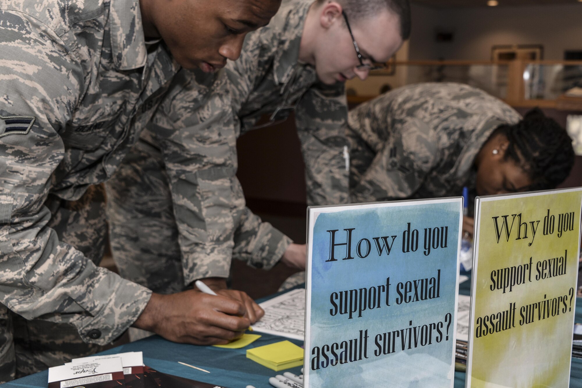 Airmen from the 70th Intelligence, Surveillance and Reconnaissance Wing write messages to sexual assault survivors on sticky notes as part of the Stick with Survivors project April 13. Stick with Survivors is a project created by the 70th ISRW Sexual Assault Prevention and Response office that will assist military and civilian members in showing their support for sexual assault survivors. (U.S. Air Force photo by Staff Sgt. Alexandre Montes)