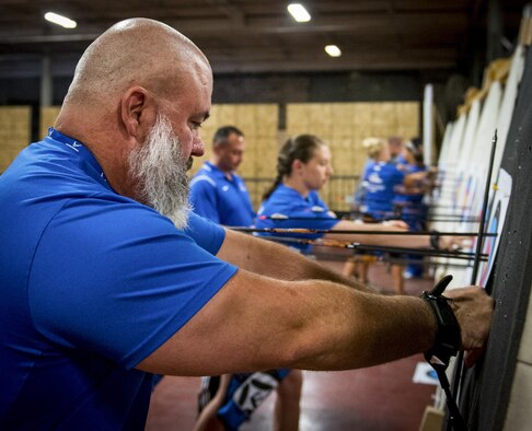 Michael Lloyd and other Warrior CARE athletes retrieve their arrows during an archery session of the adaptive sports camp at Eglin Air Force Base, Fla., April 26. The base hosts the week-long Wound Warrior CARE event that helps recovering wounded, ill and injured military members through specific hand-on rehabilitative training. (U.S. Air Force photo/Samuel King Jr.)