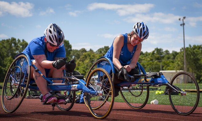 Jamie Biviano and Melinda Smith, Warrior Games athletes, prepare to race around the track in their sport chairs during a track and field session at the Air Force team’s training camp at Eglin Air Force Base, Fla., April 26. The base-hosted, week-long Warrior Games training camp is the last team practice session before the yearly competition in June. (U.S. Air Force photo/Samuel King Jr.)