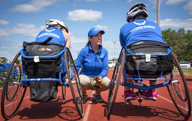 Warrior Games coach, Teresa Skinner, talks with athletes before their practice during a track and field session at the Air Force team’s training camp at Eglin Air Force Base, Fla., April 26. The base-hosted, week-long Warrior Games training camp is the last team practice session before the yearly competition in June. (U.S. Air Force photo/Samuel King Jr.)