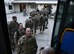 Airmen from the 555th Fighter Squadron and Soldiers from the 173rd Airborne Brigade enter a bus at Aviano Air Base, Italy, April 19, 2017. The two units deployed to Bagram Airfield, Afghanistan. (U.S. Air Force photo by Airman 1st Class Ryan Brooks)