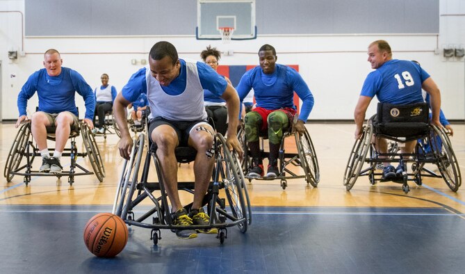 A Warrior CARE athlete races to catch up to a loose ball during the wheelchair basketball session of the adaptive sports camp at Eglin Air Force Base, Fla., April 26. The base hosts the week-long Wound Warrior CARE event that helps recovering wounded, ill and injured military members through specific hand-on rehabilitative training. (U.S. Air Force photo/Samuel King Jr.)