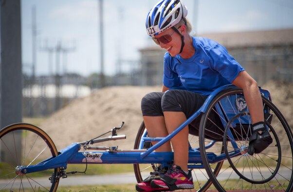 A Warrior CARE athlete enjoys her first experience on a sports chair during the track and field session of the adaptive sports camp at Eglin Air Force Base, Fla., April 26. The base hosts the week-long Wound Warrior CARE event that helps recovering wounded, ill and injured military members through specific hand-on rehabilitative training. (U.S. Air Force photo/Samuel King Jr.)
