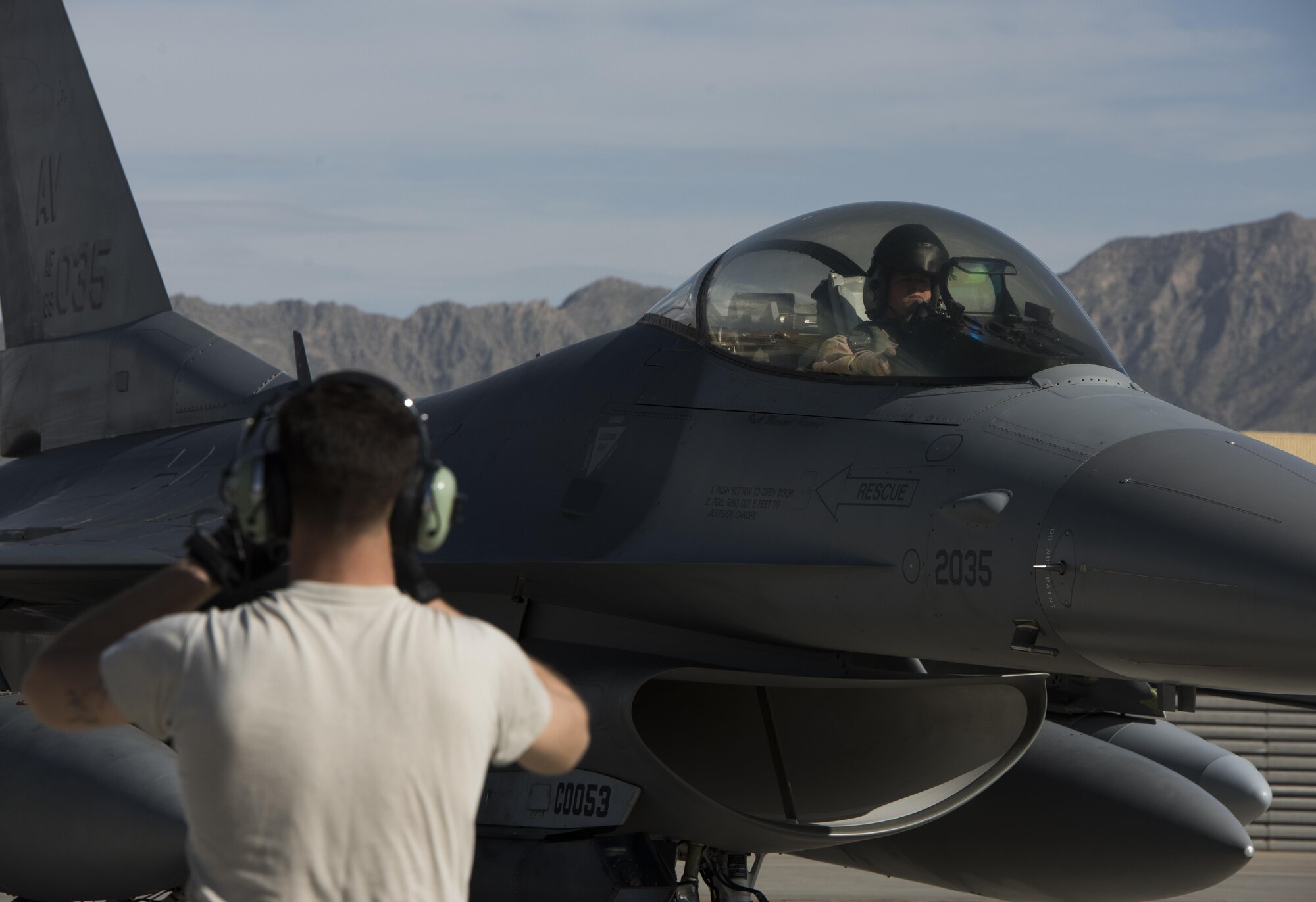 Airman 1st Class Nicolas Smith, a 455th Expeditionary Aircraft Maintenance Squadron crew chief, marshals an F-16 Fighting Falcon April 25, 2017, on Bagram Airfield, Afghanistan. F-16 Fighting Falcons from the 555th Fighter Squadron, Aviano Air Base, Italy, deployed to Bagram Airfield as part of a constant rotation of fighter aircraft. (U.S. Air Force photo by Staff Sgt. Benjamin Gonsier)