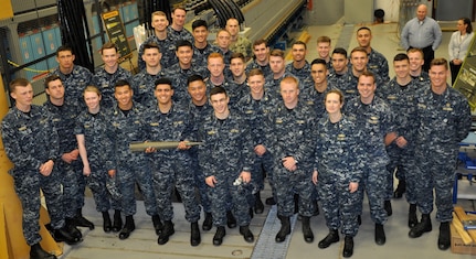 DAHLGREN, Va. (April 14, 2017) - U.S. Naval Academy Midshipmen are pictured in front of the electromagnetic railgun prototype launcher at Naval Surface Warfare Center Dahlgren Division. Navy scientists and engineers briefed the Midshipmen on electromagnetic launchers, hypervelocity projectiles, and directed energy weapons, in addition to the command's capabilities in complex warfare systems development and integration to incorporate electric weapons technology into existing and future fighting forces and platforms.