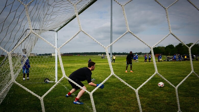 A Royal air force Airman prepares to block a soccer ball, during the ATLANTIC TRIDENT 17 soccer tournament, at Joint Base Langley-Eustis, Va., April 22, 2017. The U.S. Air Force, RAF and French air force Airmen, who participated during the exercise, were given the opportunity to socialize with each other while putting their athleticism on display during the tournament. (U.S. Air Force photo/Staff Sgt. Areca T. Bell)