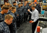 DAHLGREN, Va. (April 14, 2017) - Naval Surface Warfare Center Dahlgren Division (NSWCDD) Electromagnetic Railgun Lead Systems Engineer Chester Petry explains railgun components and technology to U.S. Naval Academy Midshipmen. Since 2008, Midshipmen have taken an annual field trip to NSWCDD to see new and emerging technologies they may work with at some point in their future careers as commissioned officers.