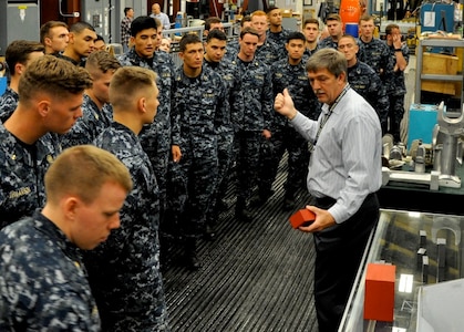 DAHLGREN, Va. (April 14, 2017) - Naval Surface Warfare Center Dahlgren Division (NSWCDD) Electromagnetic Railgun Lead Systems Engineer Chester Petry explains railgun components and technology to U.S. Naval Academy Midshipmen. Since 2008, Midshipmen have taken an annual field trip to NSWCDD to see new and emerging technologies they may work with at some point in their future careers as commissioned officers.