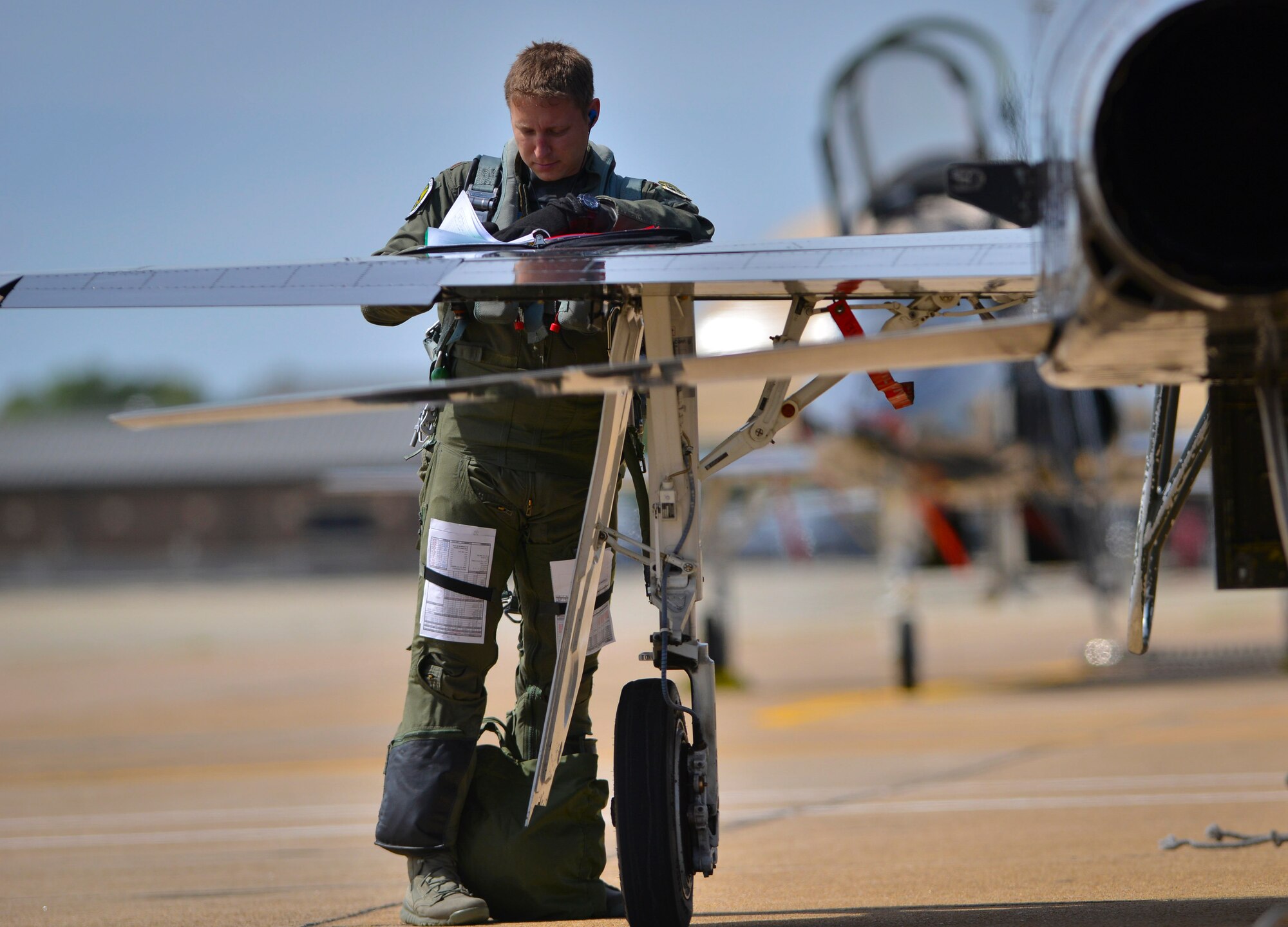 U.S. Air Force Maj. Nathaniel Lightfoot, 71st Fighter Training Squadron aggressor pilot, fills out a mission data sheet after returning from an air combat training mission during ATLANTICTRIDENT 17 at Joint Base Langley-Eustis, Va., April 18, 2016. The exercise's intent is to allow for the sharing and development of techniques, tactics, and procedures between U.S. Air Force, French Air Force, and Royal Air Force frontline fighters in order to fly, fight, and win in modern highly-contested, anti-access/area denial environments. (U.S. Air Force photo/Staff Sgt. Natasha Stannard)