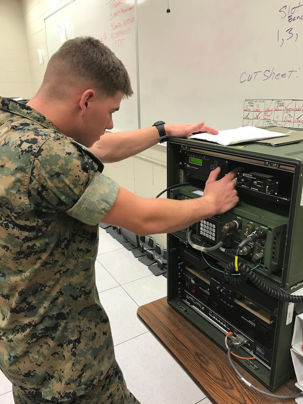 Lance Cpl. Jeffrey J. Elking Jr troubleshoots the MRC-142C, which provides medium-range Ultra High Frequency (UHF) line-of-sight, point-to-point radio communications over a distance of up to 35 miles.  This is necessary as part of his training within Ground Radio Repair Course to provide critical troubleshooting information for later use identifying the broken component to be sent in for repairs.  Elking will attain the MOS 2841 and become a Radio Repairer.  The Marine will then move on to the Marine Corps Reserve to provide technical support to the communication field.