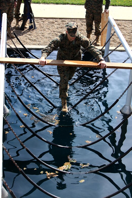 A Marine Corps officer candidate navigates an obstacle while participating in an obstacle course aboard Camp Dodge, Johnston, Iowa, April 22, 2017. The Officer Candidate School (OCS) preparation weekend was held to enhance readiness through challenging and realistic training with a focus on basic Marine Corps knowledge and skills. (U.S. Marine Corps photo by Cpl. Zachery B. Martin)