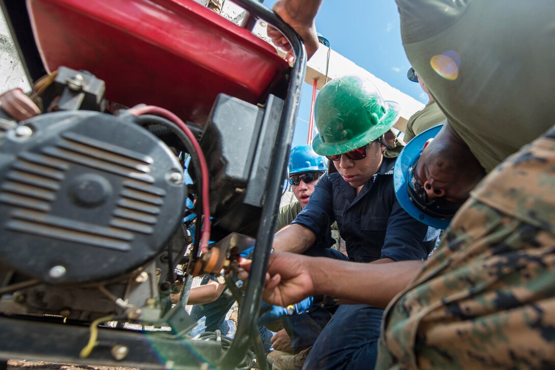 Marines repair a diesel generator during Balikatan 2017 in Ormoc, Leyte province, Philippines, April 24, 2017. Philippine and U.S. military engineers worked together to build a new classroom at Don Carlos Elementary School in Ormoc. Balikatan is an annual U.S.-Philippine military bilateral exercise focused on a variety of missions, including humanitarian assistance and disaster relief and counterterrorism. The increased interoperability will enhance readiness of humanitarian assistance and disaster relief capabilities. Navy photo by Petty Officer 2nd Class Markus Castaneda