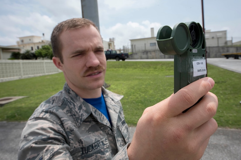 Air Force Airman 1st Class Joshua Tuckett, a weather apprentice with the 18th Operations Support Squadron weather flight, collects weather data using a kestrel reader at Kadena Air Base, Japan, April 21, 2017. The device measures air pressure, relative humidity, wind speed and direction. Air Force photo by Senior Airman John Linzmeier