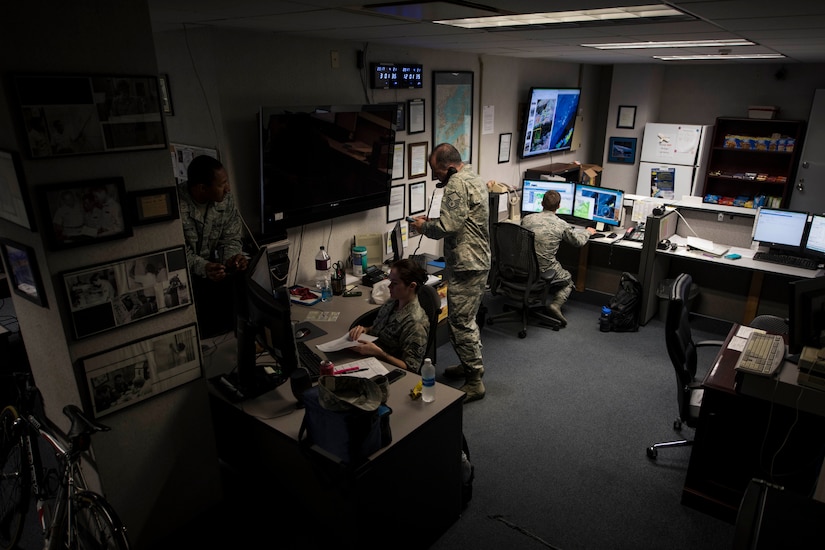 Members of the 18th Operations Support Squadron weather flight monitor weather conditions April 21, 2017, at Kadena Air Base, Japan. The information gathered will be used to update slides viewed by pilots keeping them informed on weather conditions they are likely to encounter while flying. (U.S. Air Force photo by Senior Airman John Linzmeier)