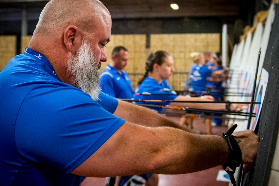 Michael Lloyd and other Warrior CARE athletes retrieve their arrows during an adaptive sports camp at Eglin Air Force Base, Fla., April 26, 2017. Air Force photo by Samuel King Jr.