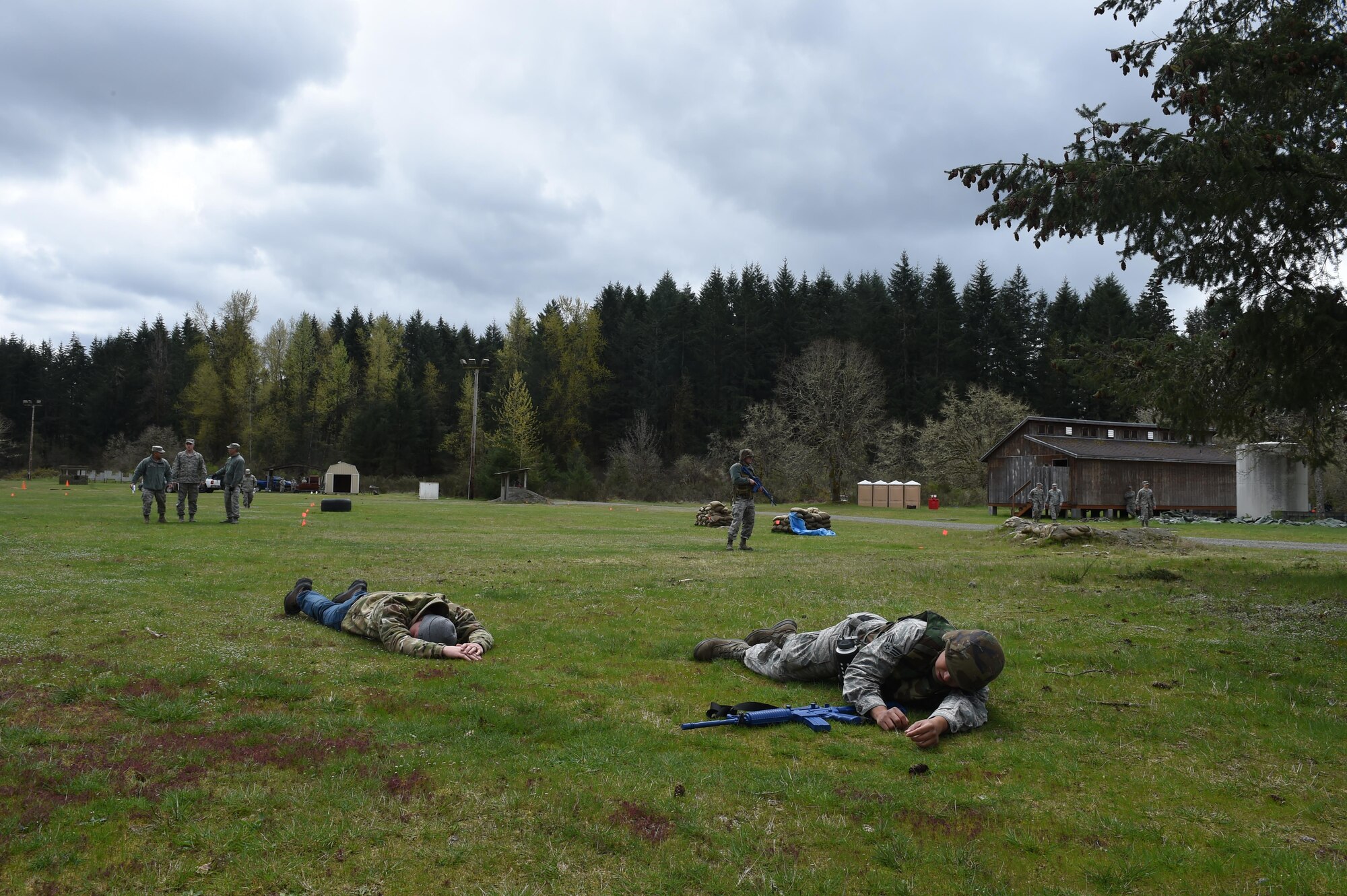 627th Civil Engineer Squadron Airmen simulate experiencing an attack by a suicide bomber during their internal Capstone exercise April 20, 2017 at Joint Base Lewis-McChord, Wash. The capstone was a validation of the unit’s last several training days for the 627th CES have included land navigation training and air base defense training. (U.S. Air Force photo/ Staff Sgt. Naomi Shipley)