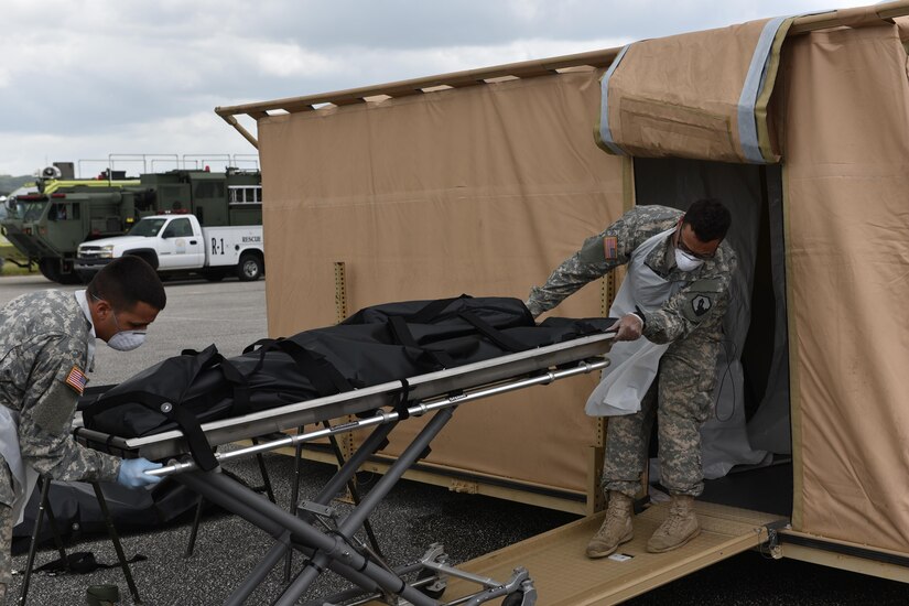 Soldiers assigned to the 311th Quartermaster Company (Mortuary Affairs) prepare to process the remains of the deceased personal from the notional Hurricane Arlene during the Tropical Journey exercise held at the Rafael Hernandez Airport in Aguadilla, on April 24. Tropical Journey (TJ) is a full-scale VA driven “All Hazard Preparedness Response” exercise that began in 2005 and occurs every three years. The TJ17 scenario enables participants to assess objectives and core capabilities. This full-scale exercise provides a platform for 1st Mission Support Command unit leadership to evaluate METL collective training tasks within a DSCA operational environment.